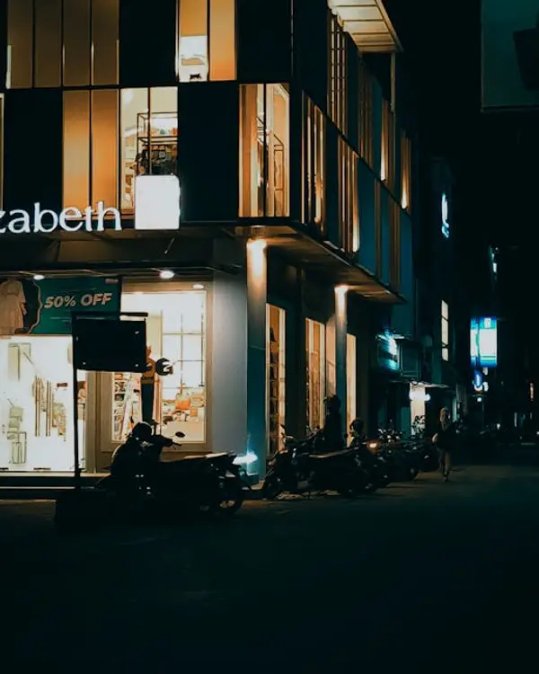 A busy city street illuminated at night