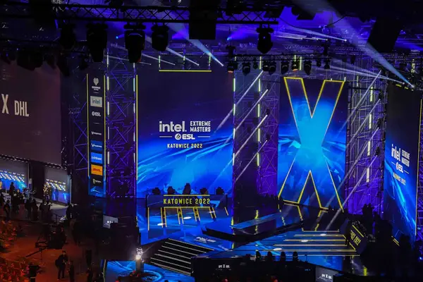 An illuminated esports arena with vibrant lights.