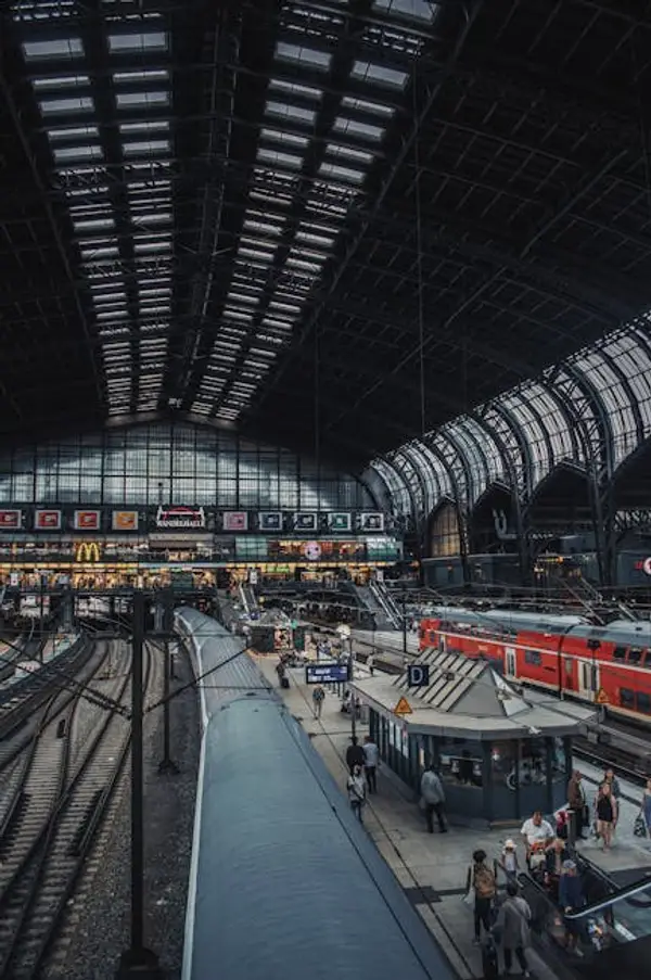 A bustling European train station with passengers boarding