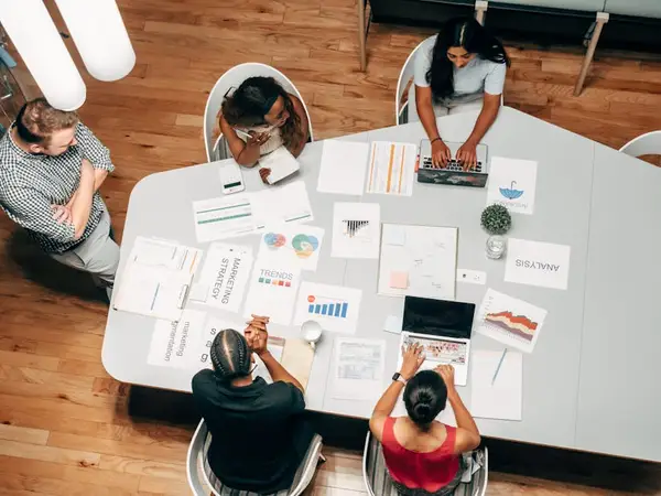 a group of people discussing in an office setting