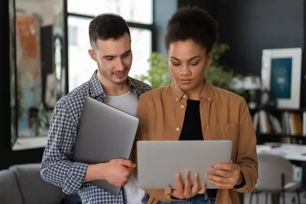 Group of people collaborating with laptops