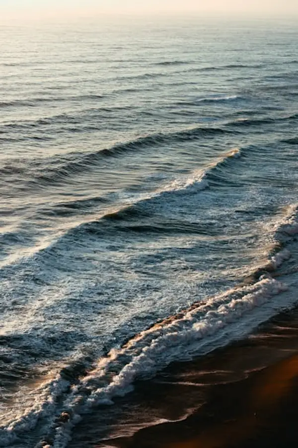 sunset over calming beach waves