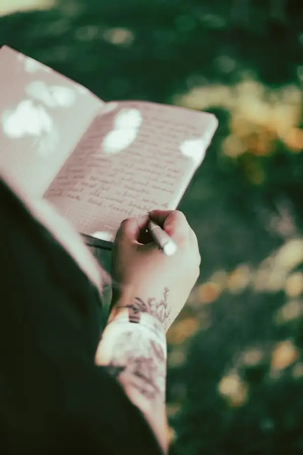 A person writing notes on a notebook